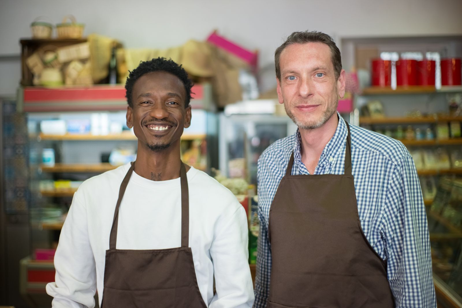 Two shop owners behind the counter — loyalty earns across every store on the network